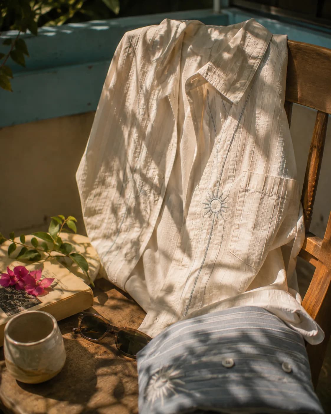 Warping Theories — shirt on a chair, sun motif at the chest